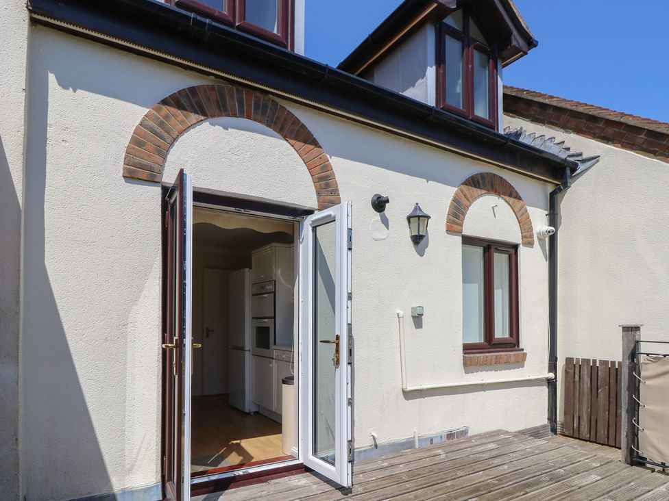 A kitchen with an open door and window at Anchorage House in Seaview
