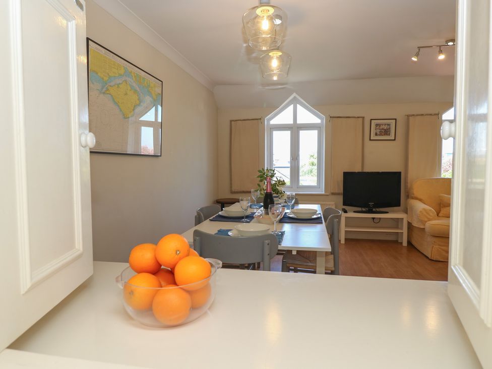 A living room with a dining table and sofa at Anchorage House in Seaview