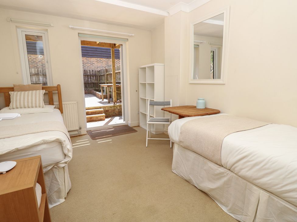 A bedroom with two beds and a table at Anchorage House Seaview