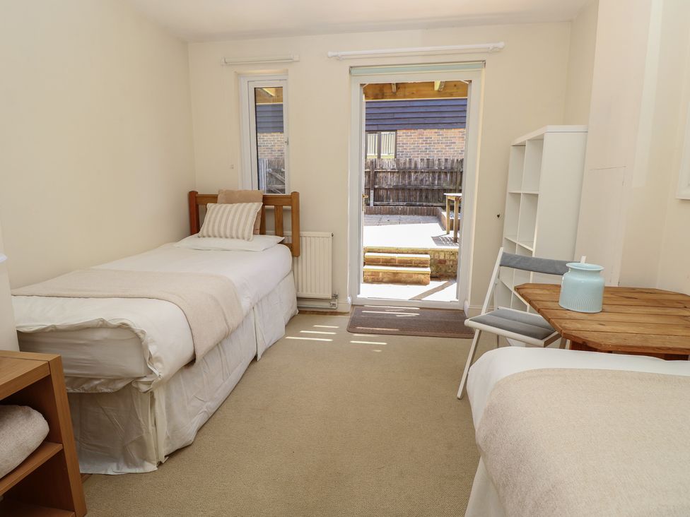 A bedroom with two beds and a table at Anchorage House in Seaview