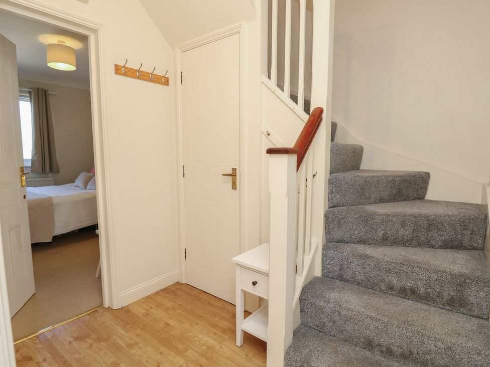 A hallway with stairs and a door at Anchorage House Seaview