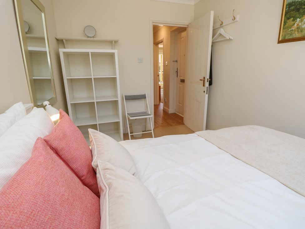 A bedroom with a bed and shelf at Anchorage House, Seaview