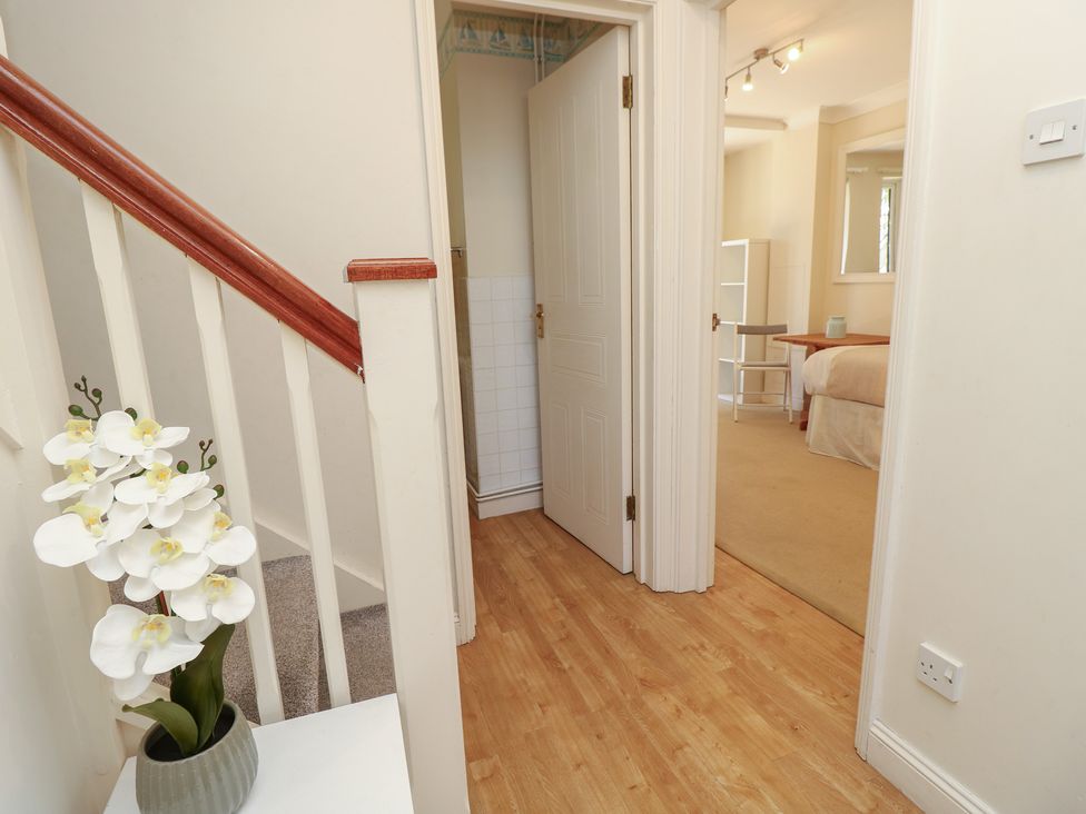 A hallway with a staircase and doors to rooms at Anchorage House Seaview