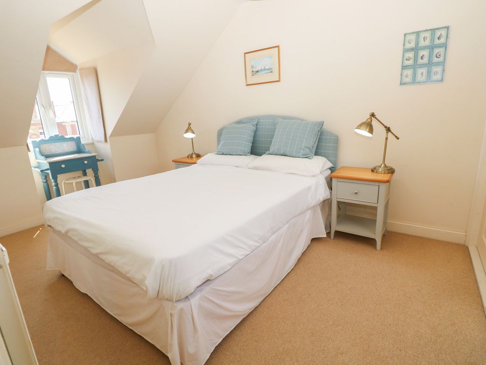 A bedroom with a bed and a table at Anchorage House Seaview