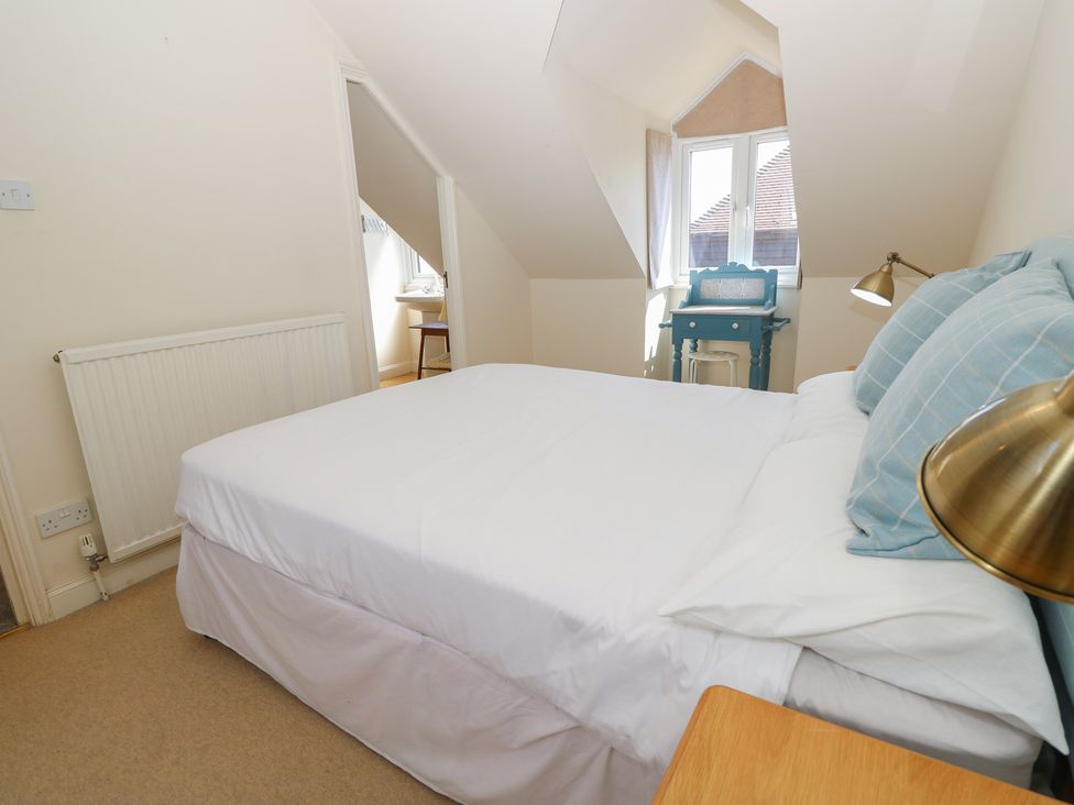 A bedroom with a bed and a desk at Anchorage House in Seaview
