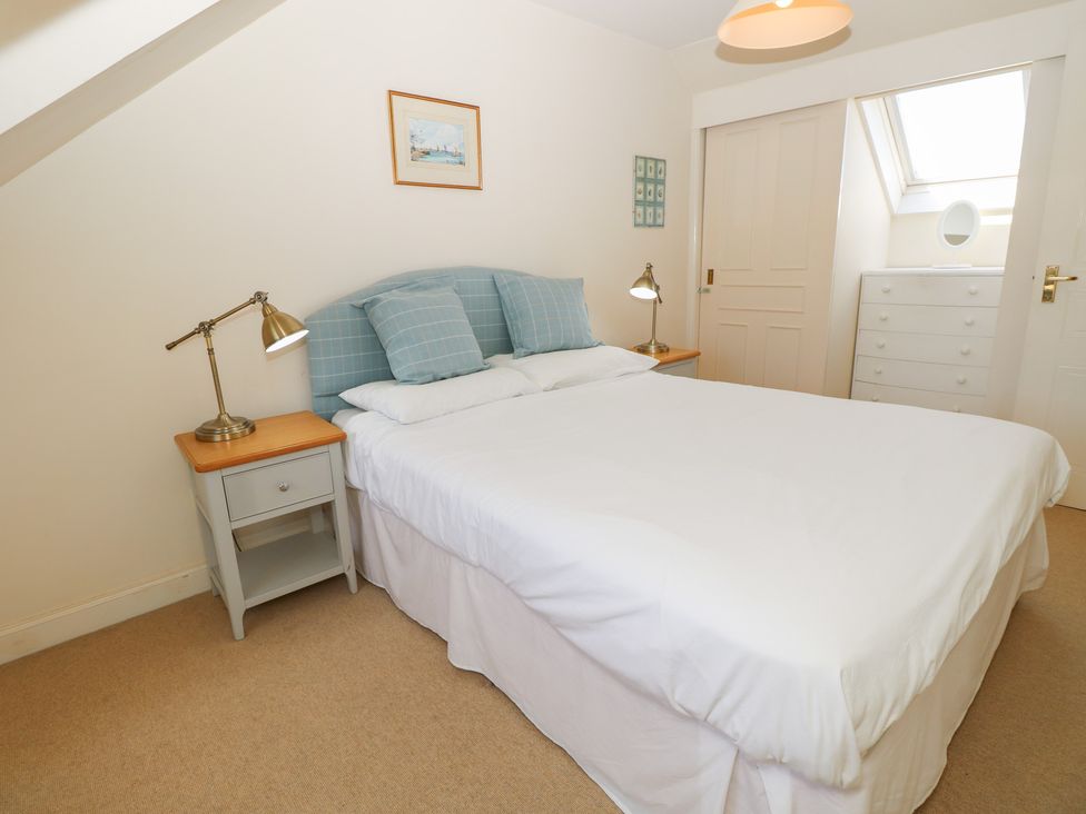 A bedroom with a bed and bedside table at Anchorage House Seaview