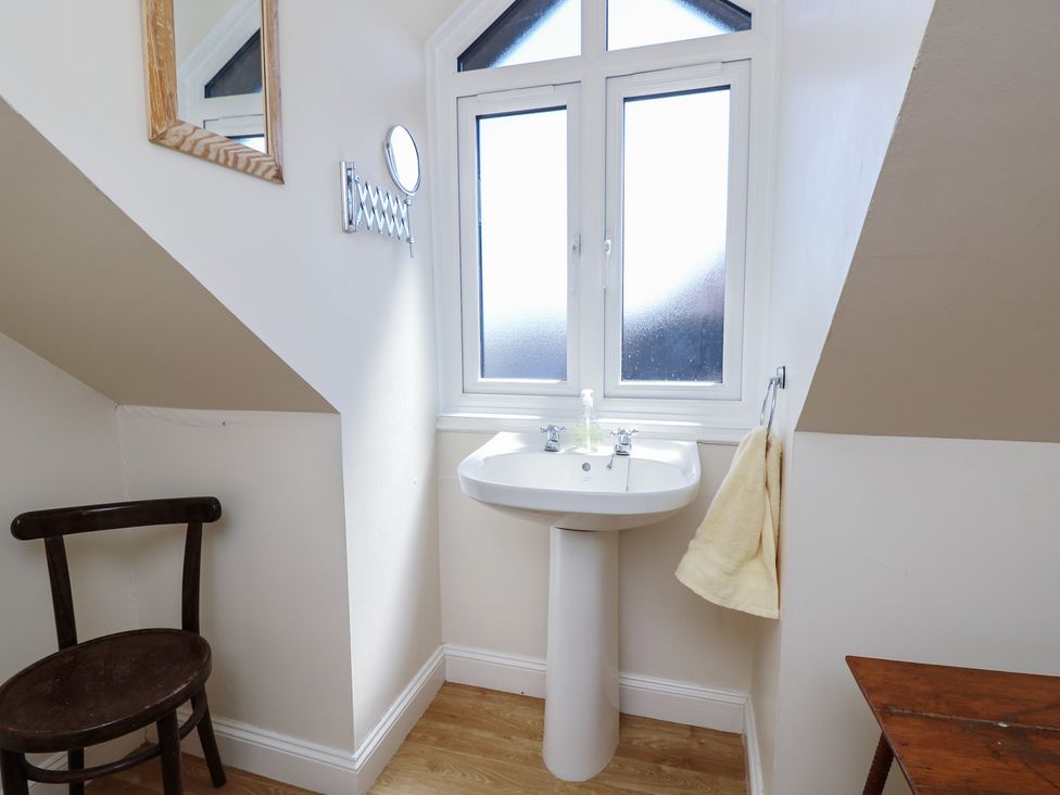 A bathroom with a sink and a mirror at Anchorage House in Seaview