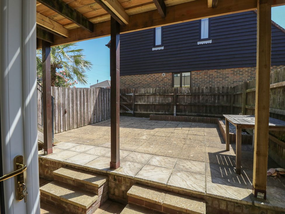 A garden with a table and paved area at Anchorage House Seaview