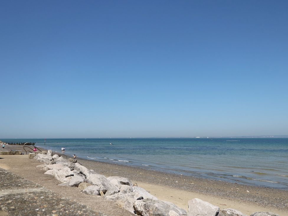 A beach with rocks and water at Anchorage House Seaview