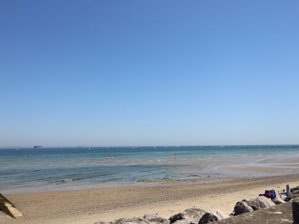 A beach with water and boats at Anchorage House in Seaview