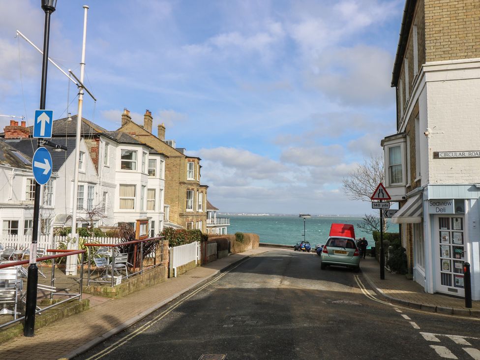 A street view with houses and cars near the sea at Anchorage House Seaview