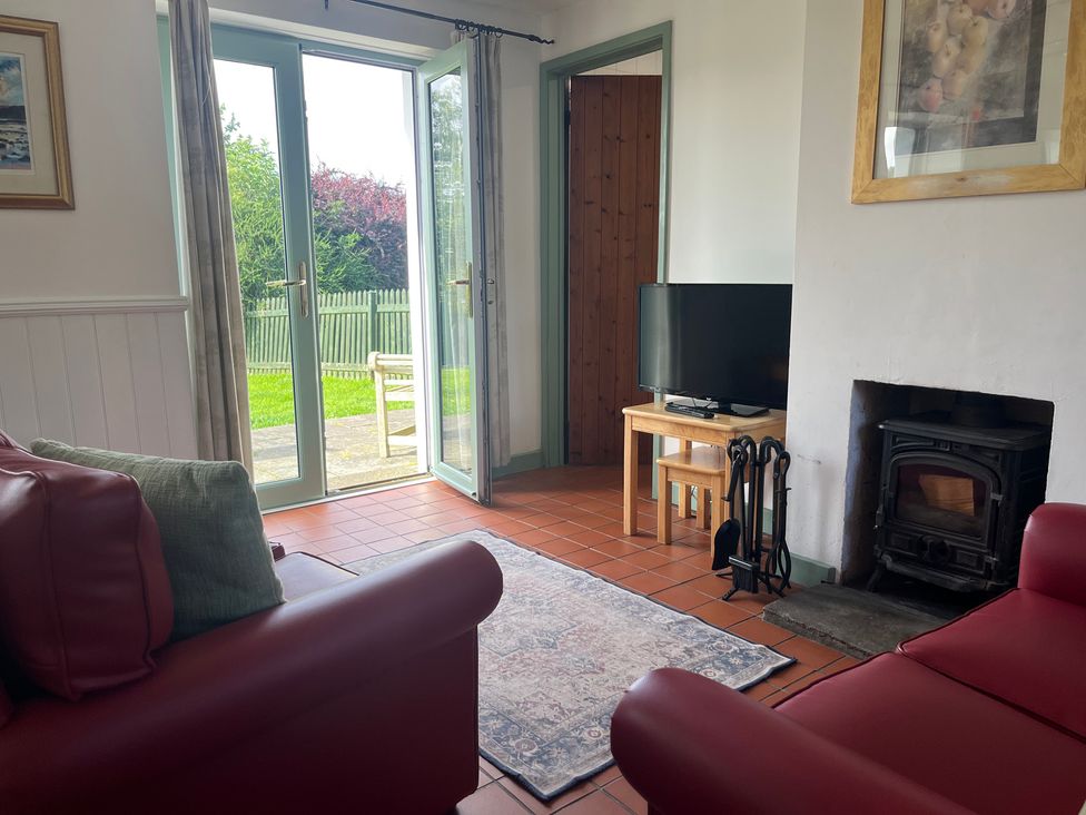 A living room with a sofa and television at Wren Cottage in Cowbridge