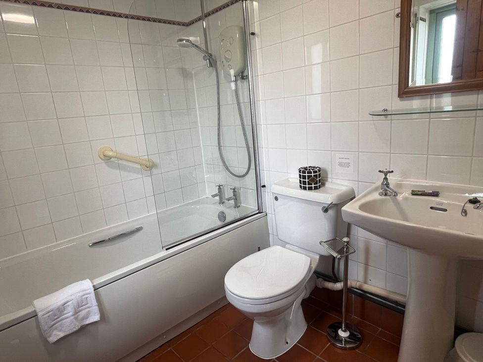 A bathroom with shower and bathtub at Wren Cottage Cowbridge