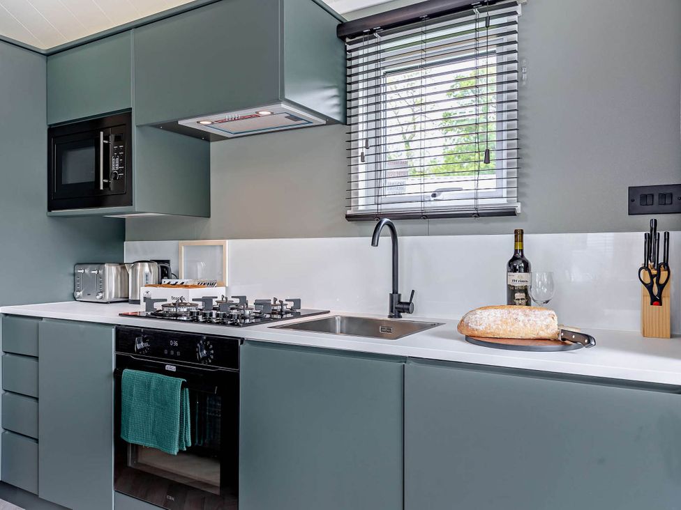 A kitchen with modern appliances and clean surfaces at Prion 1.0 Pet in Llandyrnog