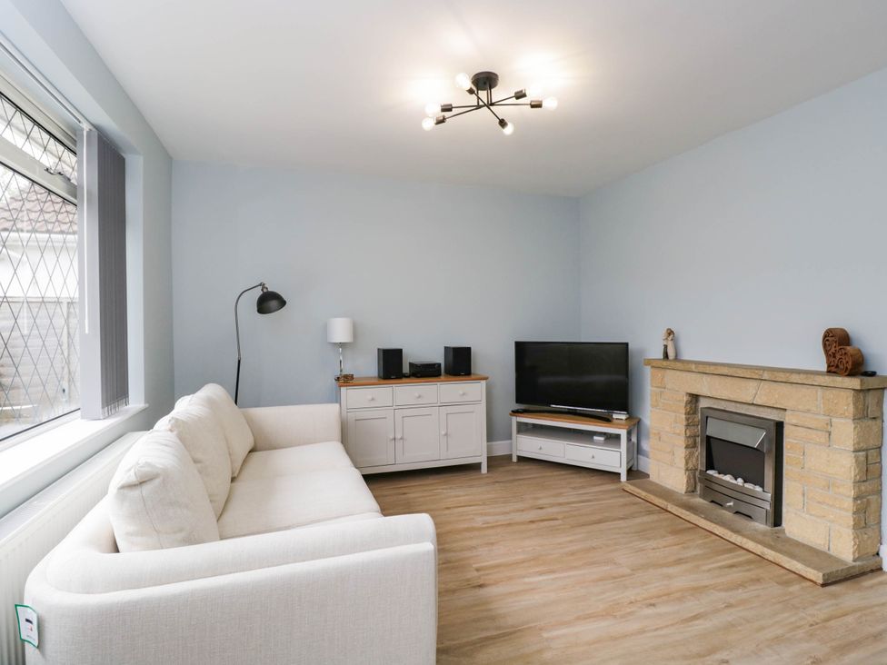 A living room with a sofa and tv at 3 Station Road Weston-Super-Mare