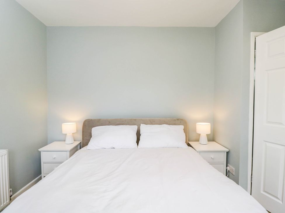 A bedroom with a bed and bedside tables at 3 Station Road in Weston-Super-Mare