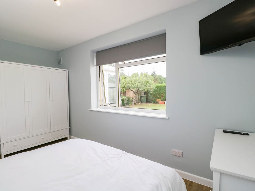 A bedroom with a bed and wardrobe at 3 Station Road Weston-Super-Mare