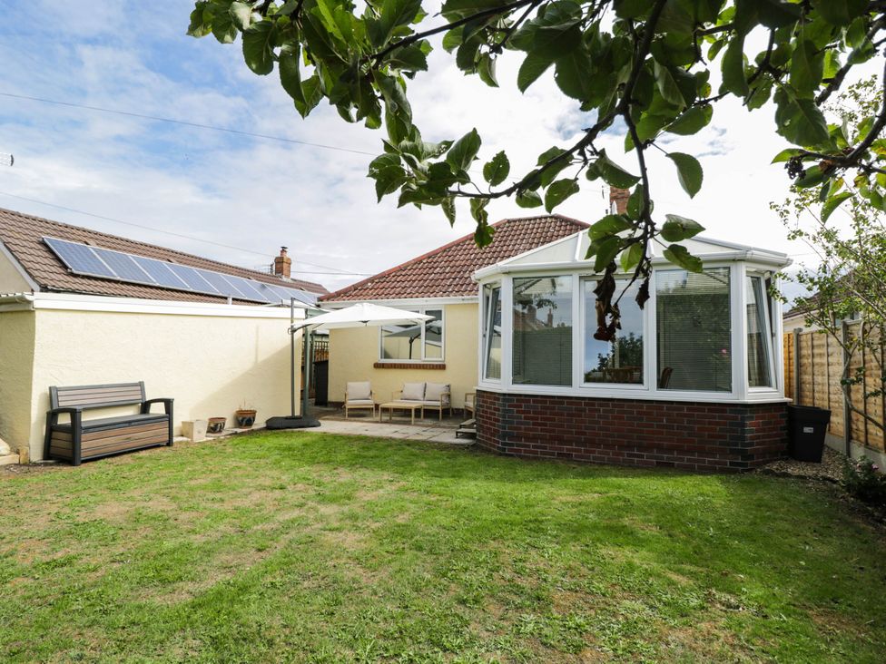 A garden with a conservatory and outdoor furniture at 3 Station Road Weston-Super-Mare
