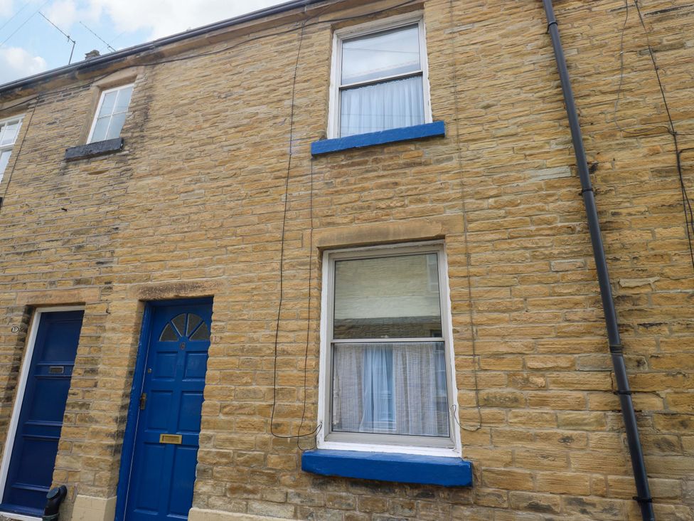 A house exterior with blue door and windows at Saltaire House in Saltaire