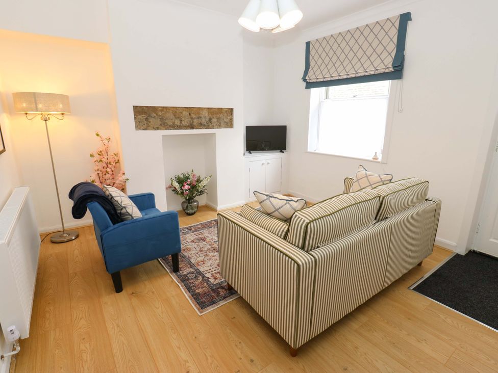 A living room with a sofa and armchair at Saltaire House in Saltaire