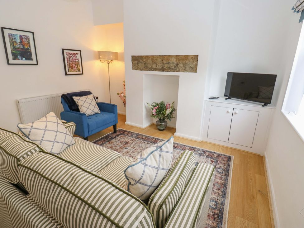 A living room with a sofa and armchair at Saltaire House in Saltaire