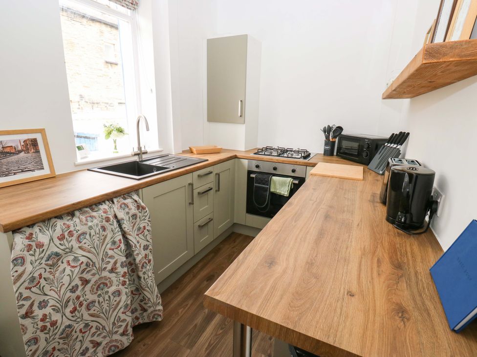 A kitchen with a sink and stove at Saltaire House in Saltaire