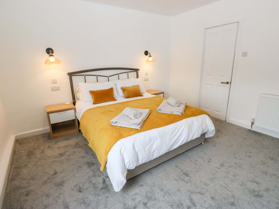 A bedroom with a bed and bedside table at Saltaire House in Saltaire