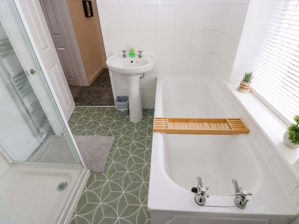 A bathroom featuring a bathtub, sink, and shower at Saltaire House, Saltaire