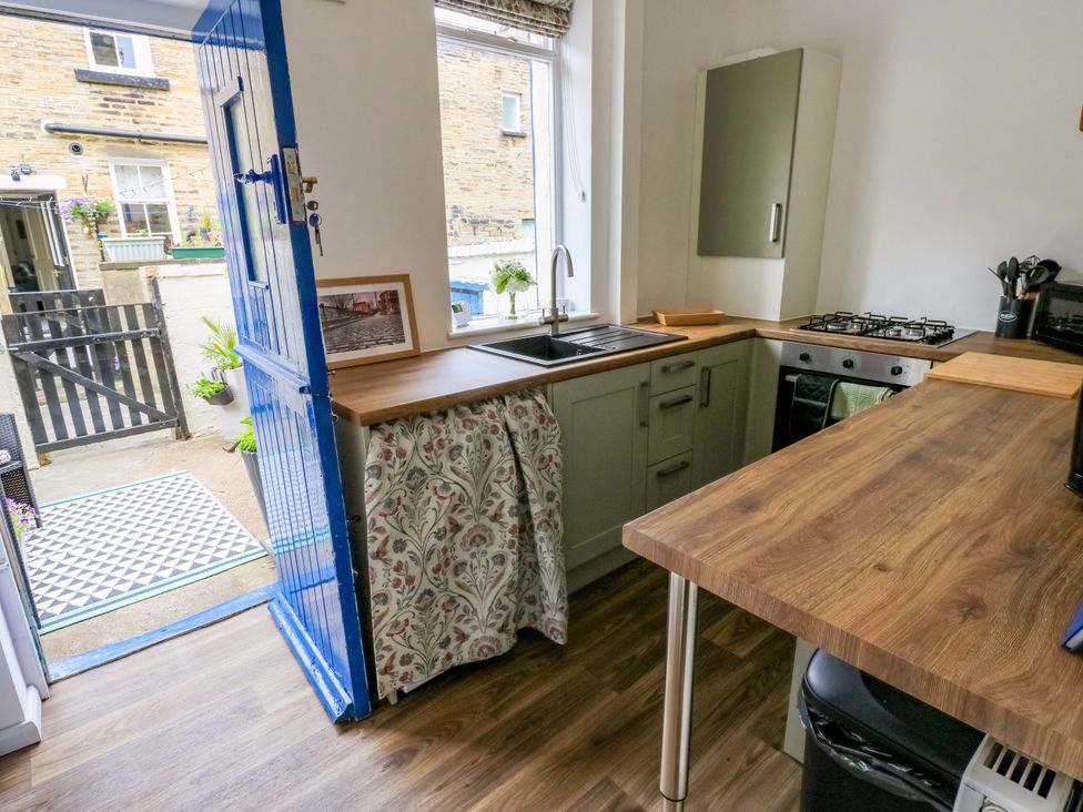 A kitchen with sink and stove at Saltaire House in Saltaire