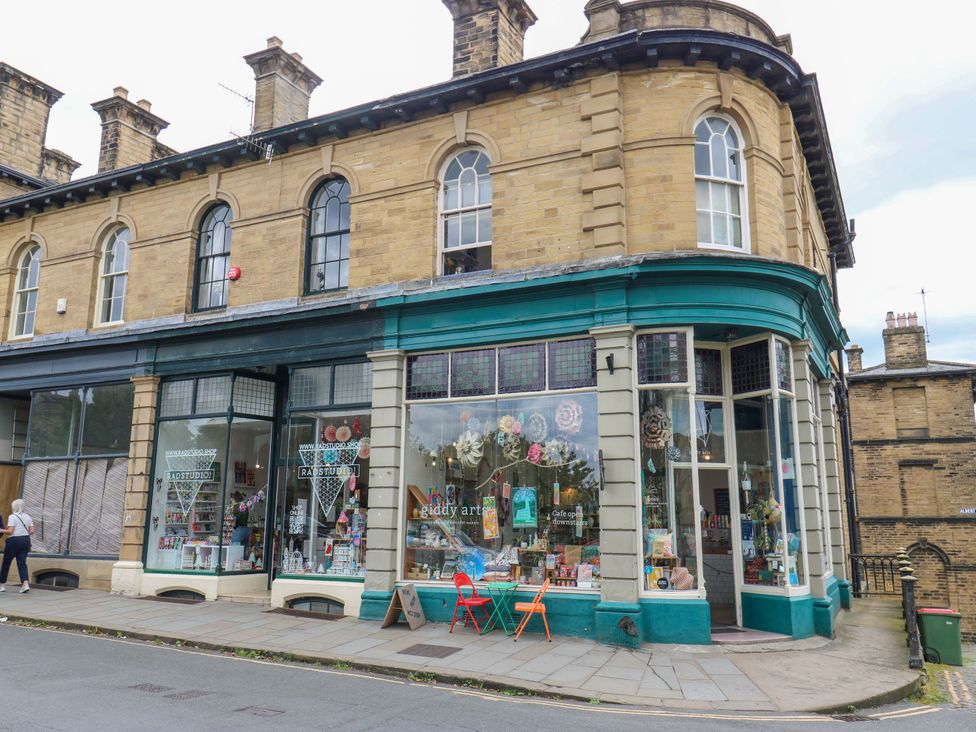 A storefront with decorative items and seating at Saltaire House in Saltaire