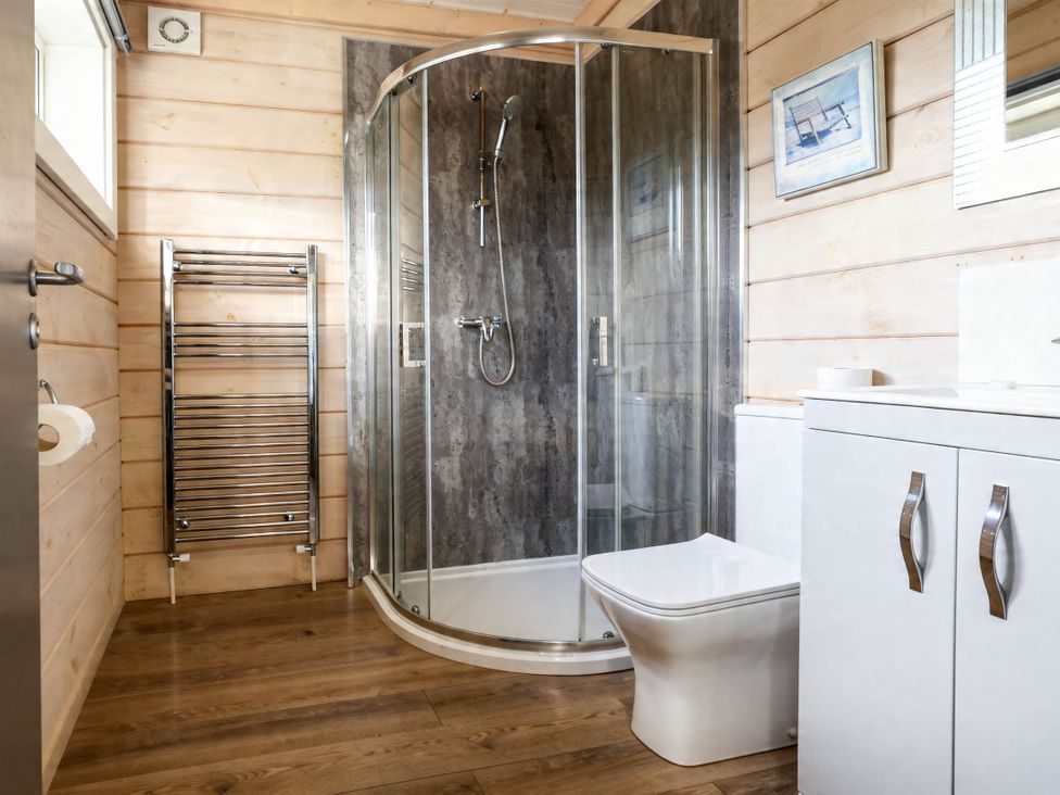 A bathroom with shower, toilet, and sink at Pine Lodge Spa Pet Thirsk