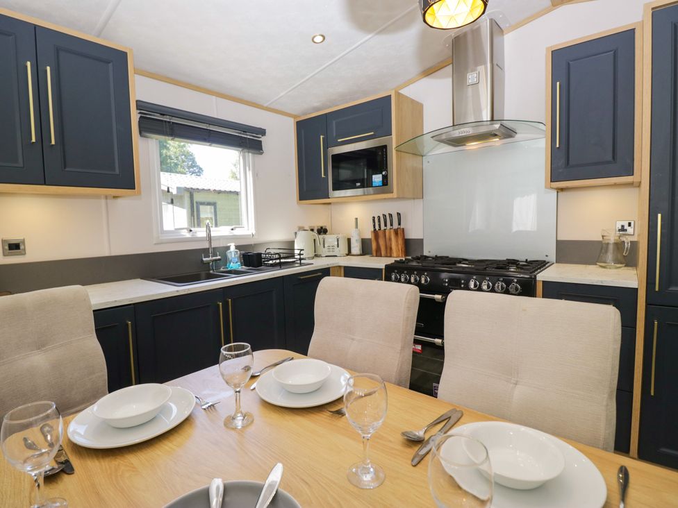 A kitchen with cabinets and cooking appliances at 51 Calgarth Park in Troutbeck