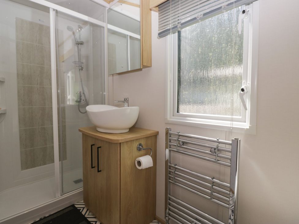 A bathroom with a shower and sink at 51 Calgarth Park in Troutbeck