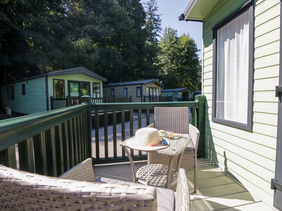 A balcony with chairs and a table at 51 Calgarth Park in Troutbeck