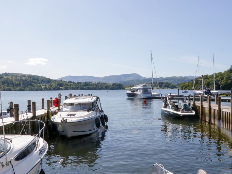 Boats moored at a dock with mountains in the background at 51 Calgarth Park, Troutbeck
