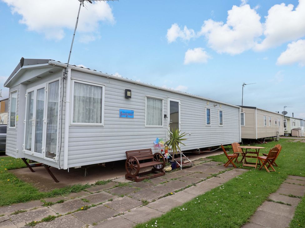A mobile home with outdoor seating at 15 Cherry Tree walk in Rhyl