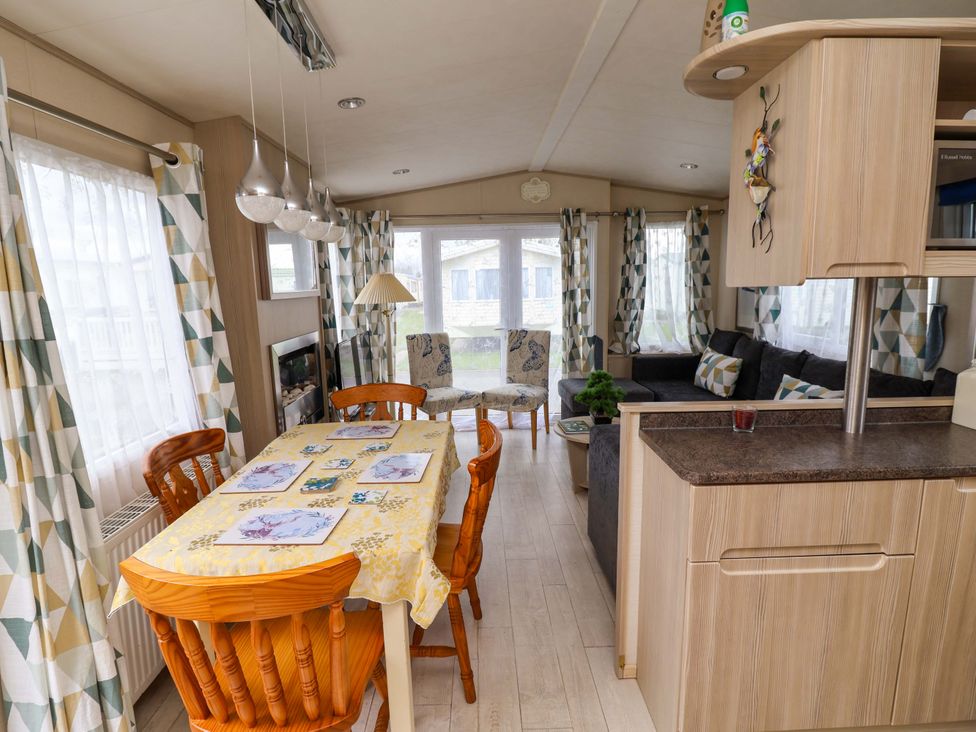A living room with a dining table and sofa at 15 Cherry Tree walk in Rhyl