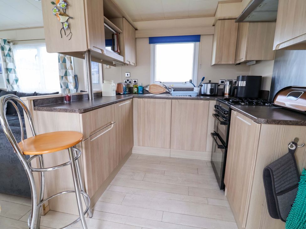 A kitchen with cabinets and appliances at 15 Cherry Tree walk Rhyl