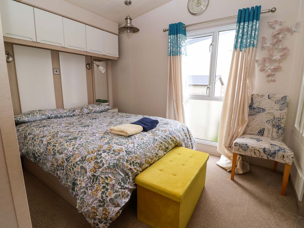 A bedroom with a bed and a chair at 15 Cherry Tree walk in Rhyl