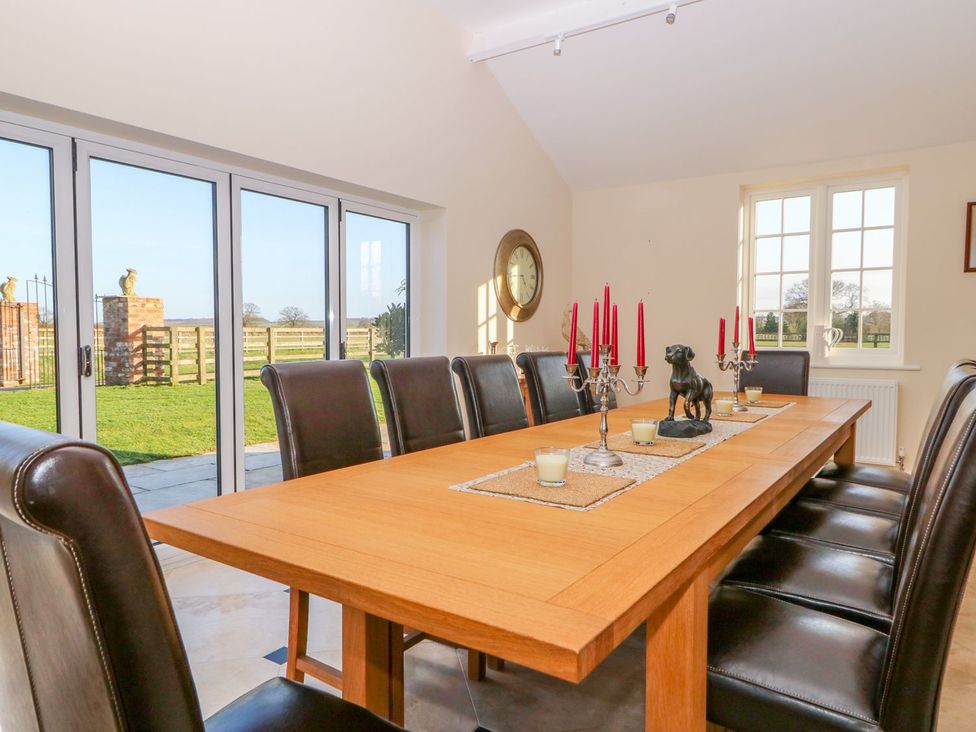 A dining room with a long table and chairs at Tuft House in Hovingham