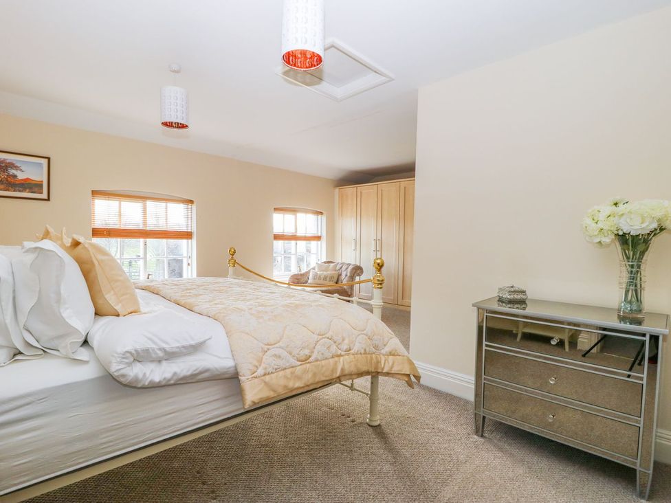 A bedroom with a bed and dresser at Tuft House in Hovingham