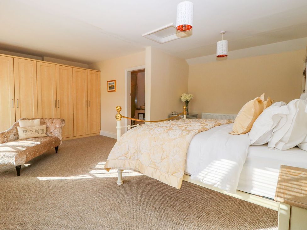 A bedroom with a bed and wardrobe at Tuft House in Hovingham