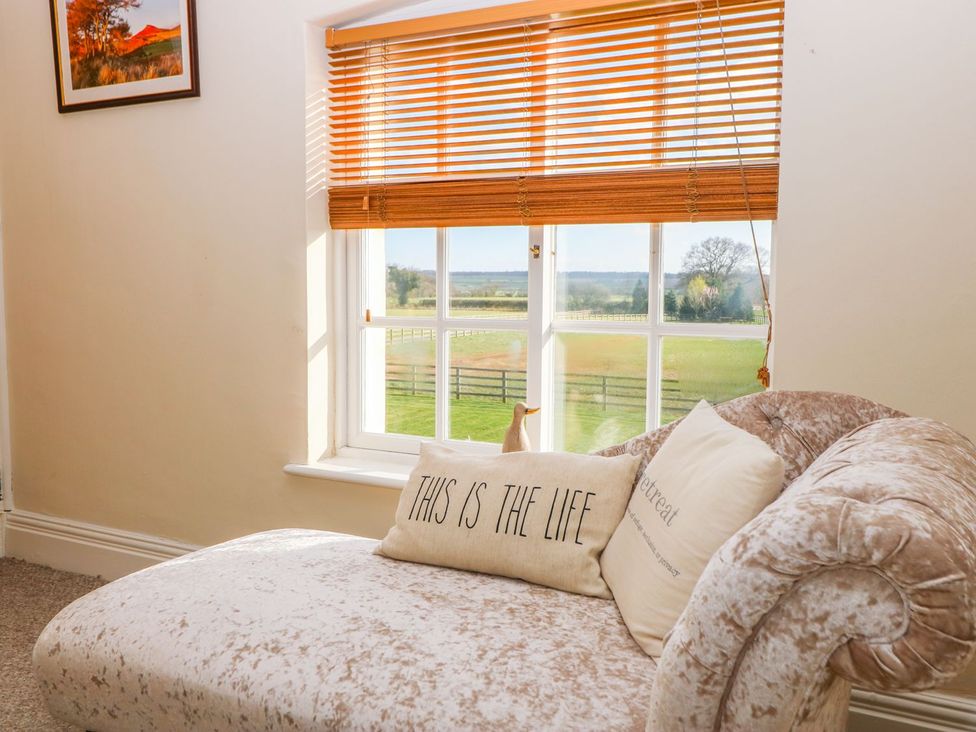 A living room with a couch and window at Tuft House in Hovingham
