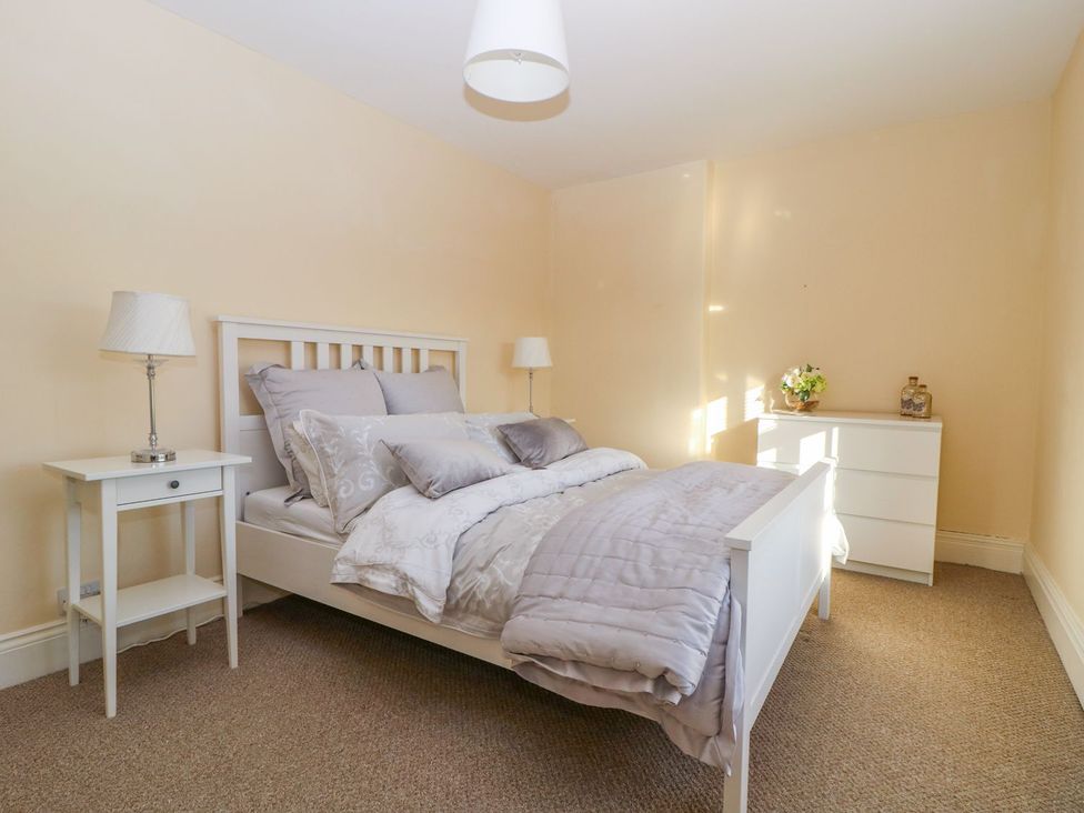 A bedroom with a bed and bedside table at Tuft House in Hovingham