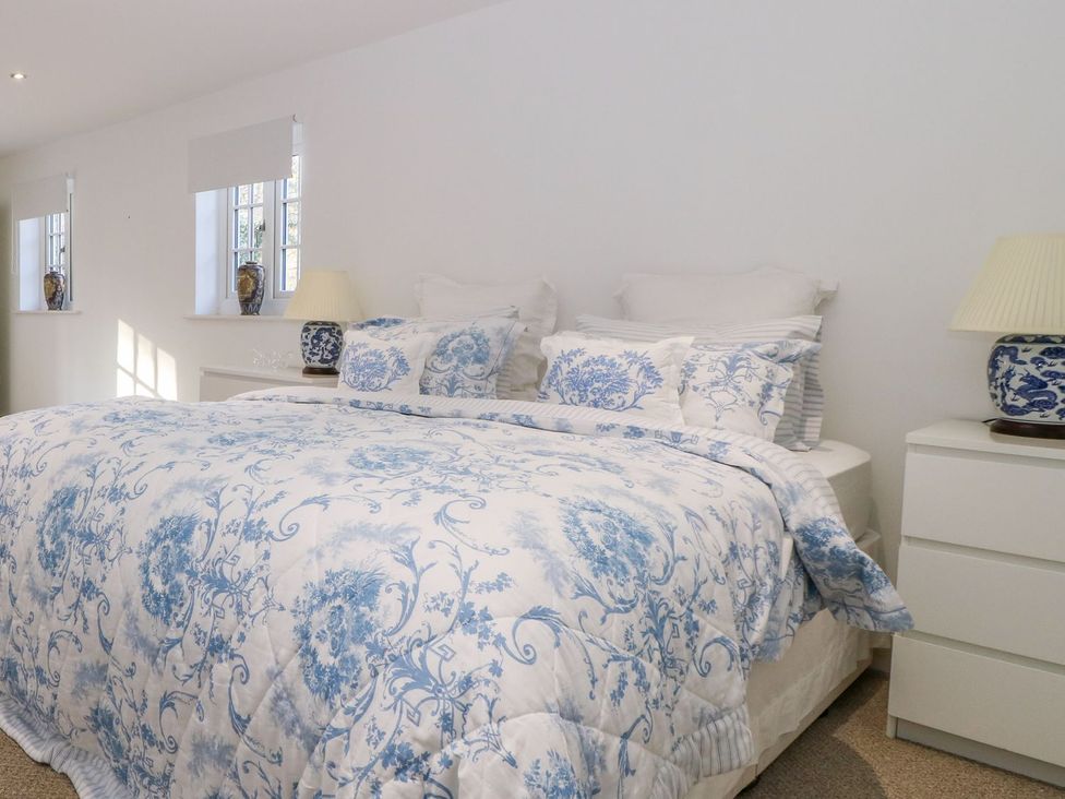 A bedroom with a bed and decorative pillows at Tuft House in Hovingham