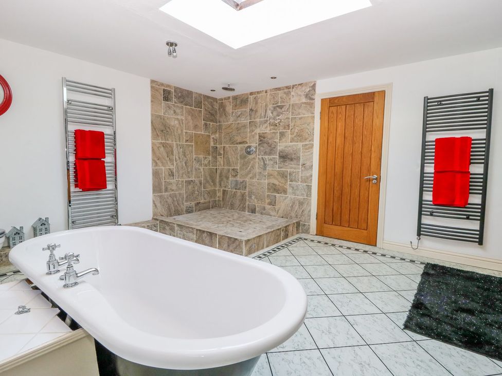 A bathroom with a bathtub and shower at Tuft House in Hovingham