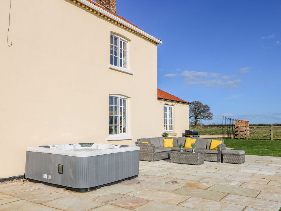 A hot tub and outdoor seating area at Tuft House in Hovingham