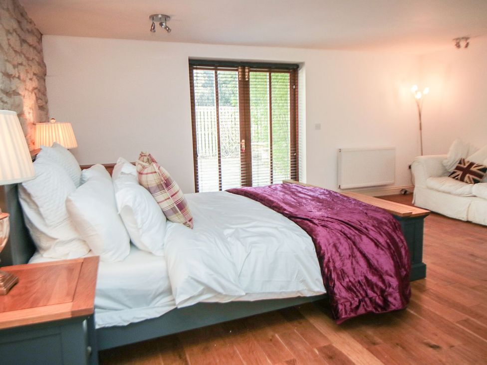 A bedroom with a bed and a window at Tuft House in Hovingham