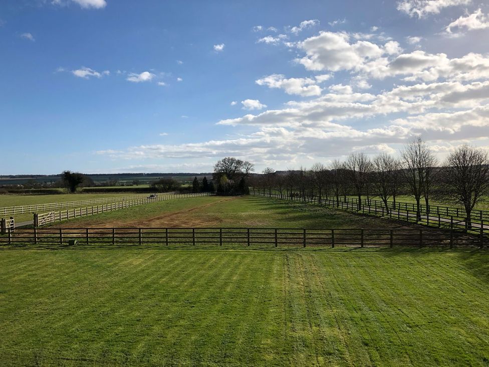 A field with fencing and trees at Tuft House in Hovingham