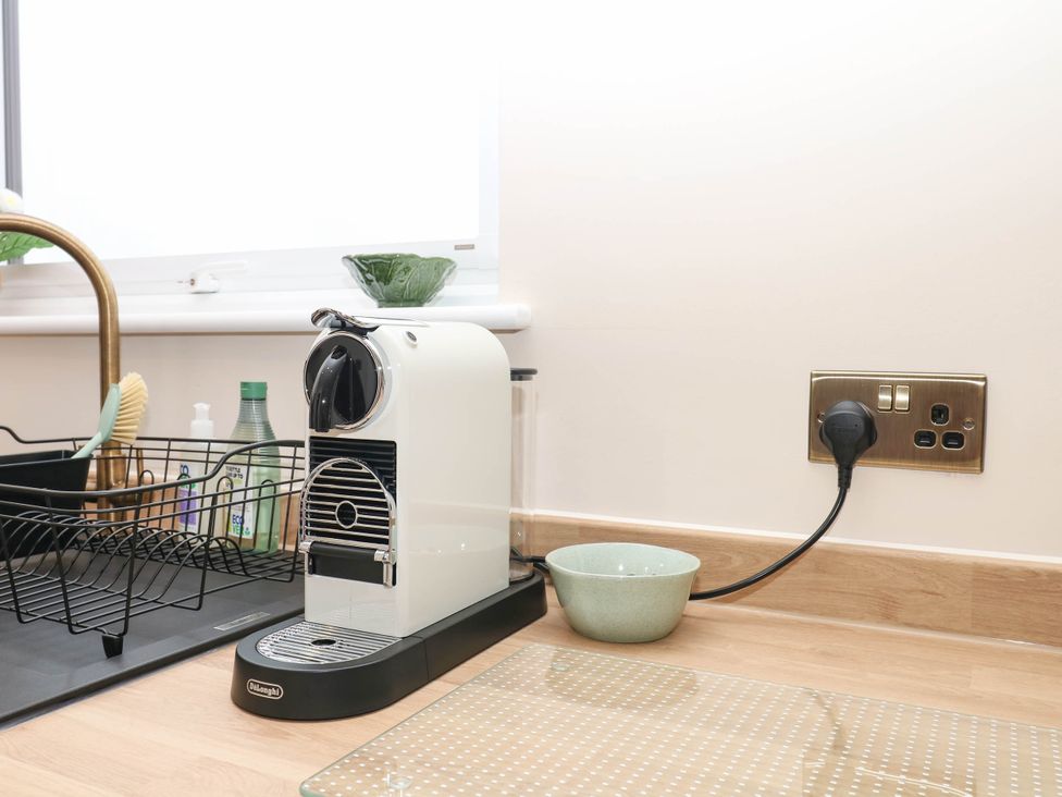 A kitchen with a Nespresso machine and dish rack at Little Folley in Whitestone near Tedburn St Mary